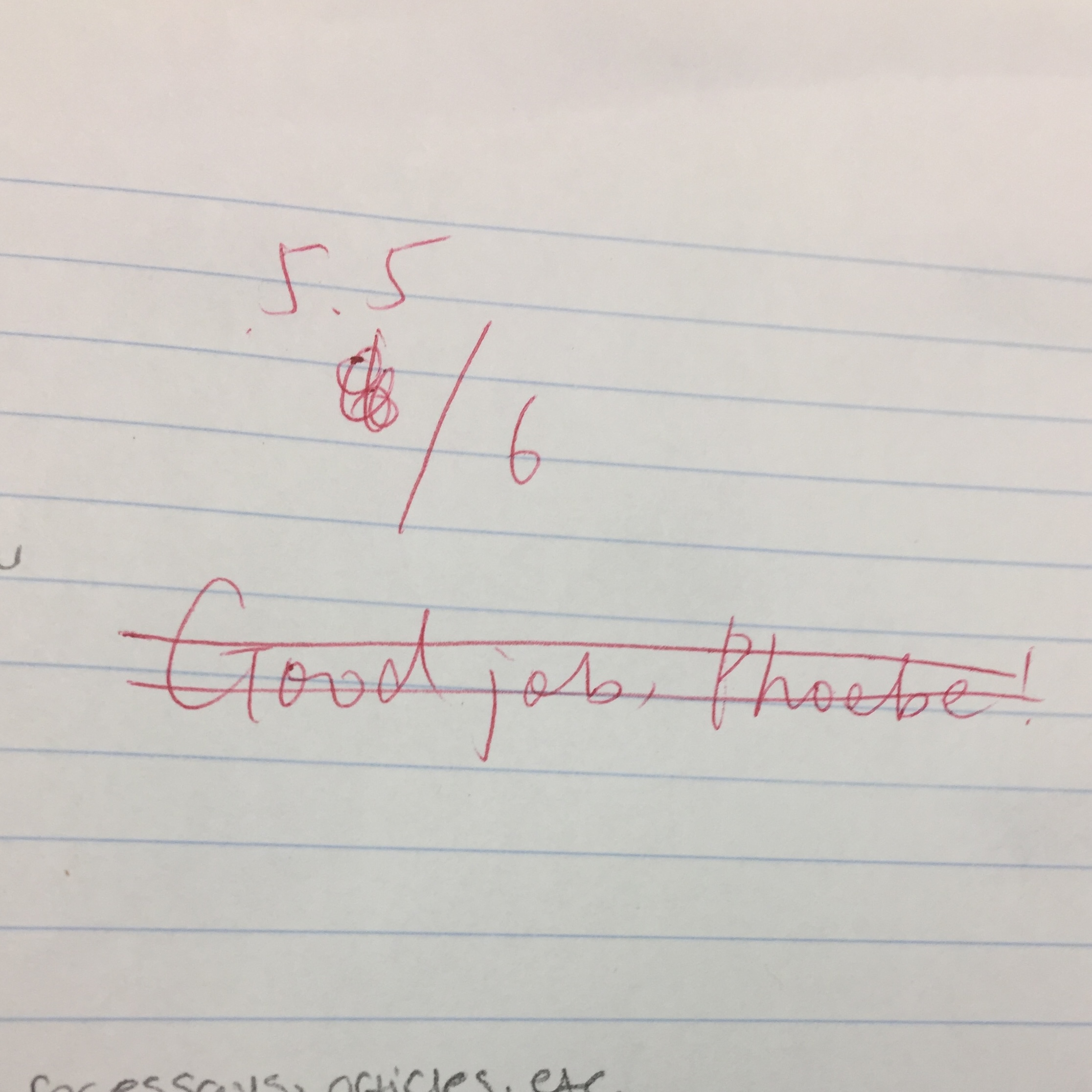 A piece of paper with red pen markings giving a score of 5.5/6. The words 'Great job Phoebe!' are crossed out